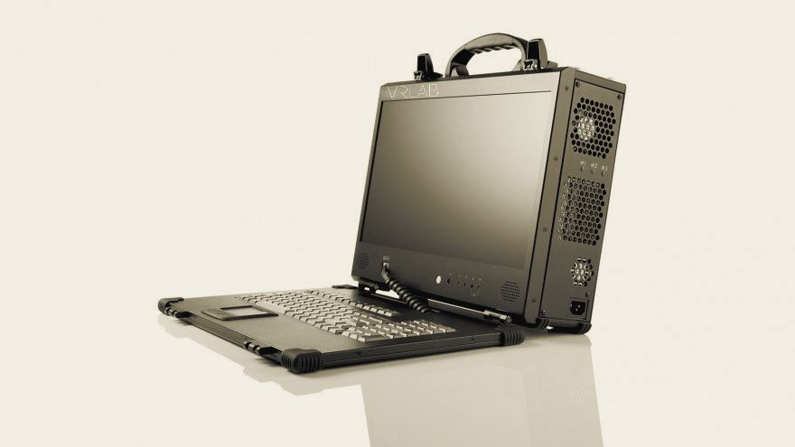 A black portable computer case standing open, its built-in screen carrying the lab's 2015 mark above a fold-down keyboard.